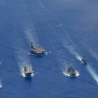 The USS Ronald Reagan Carrier Strike Group and units from the Maritime Self-Defense Force and Australian Defense Force participate in trilateral exercises in the Philippine Sea, on the doorstep of the disputed South China Sea, earlier this week. | U.S. NAVY
