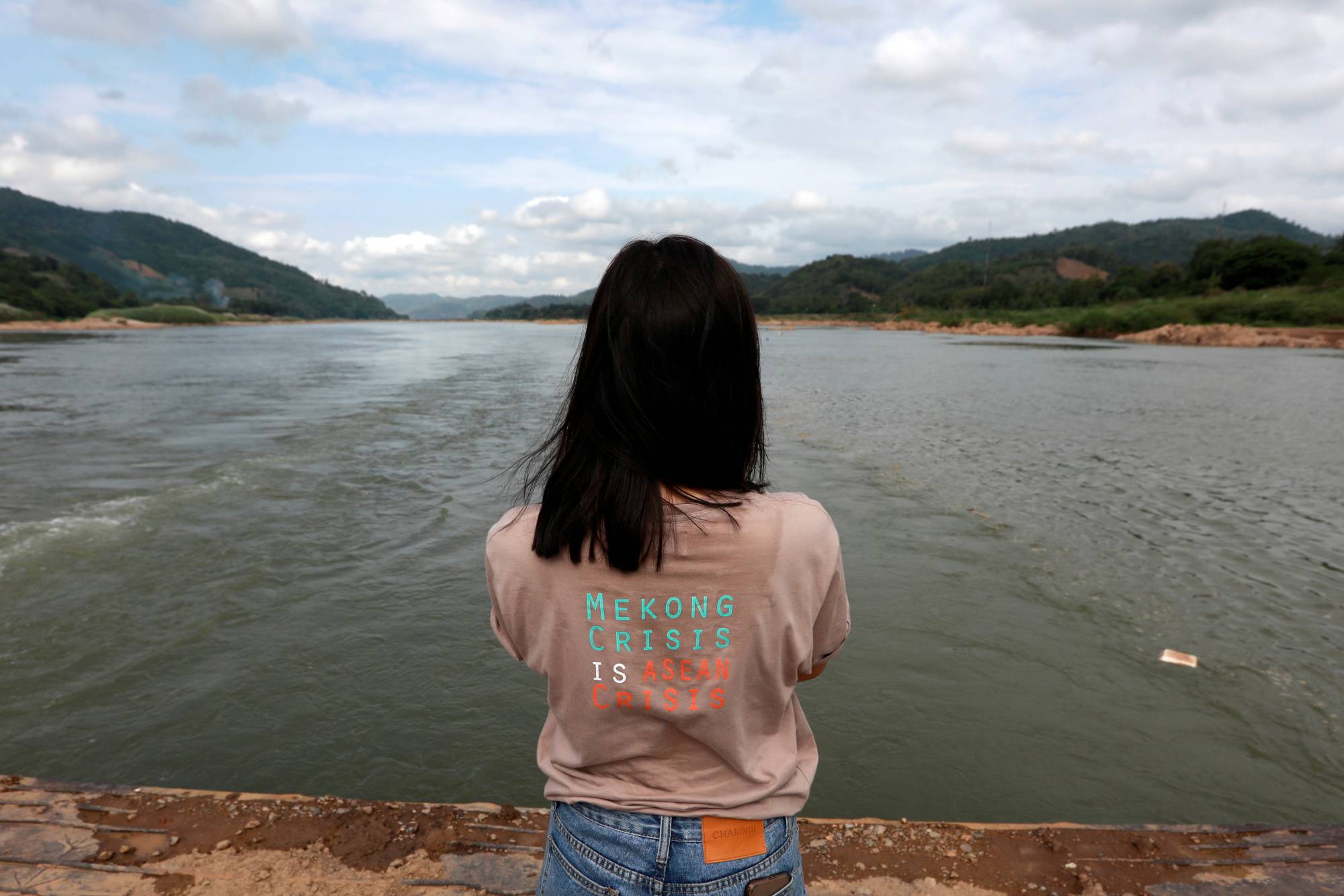 A woman stands next to the Mekong River bordering Thailand and Laos. The state of the Mekong is an urgent worry for the 60 million people who depend on it for farming and fishing as it flows from China through Southeast Asia.  | REUTERS