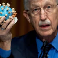 Dr Francis Collins, director of the National Institutes of Health, holds up a model of SARS-CoV-2, known as the novel coronavirus, during a U.S. Senate Appropriations Subcommittee Hearing on the plan to research, manufacture and distribute a coronavirus vaccine, known as Operation Warp Speed on Capitol Hill in Washington on July 2. | REUTERS