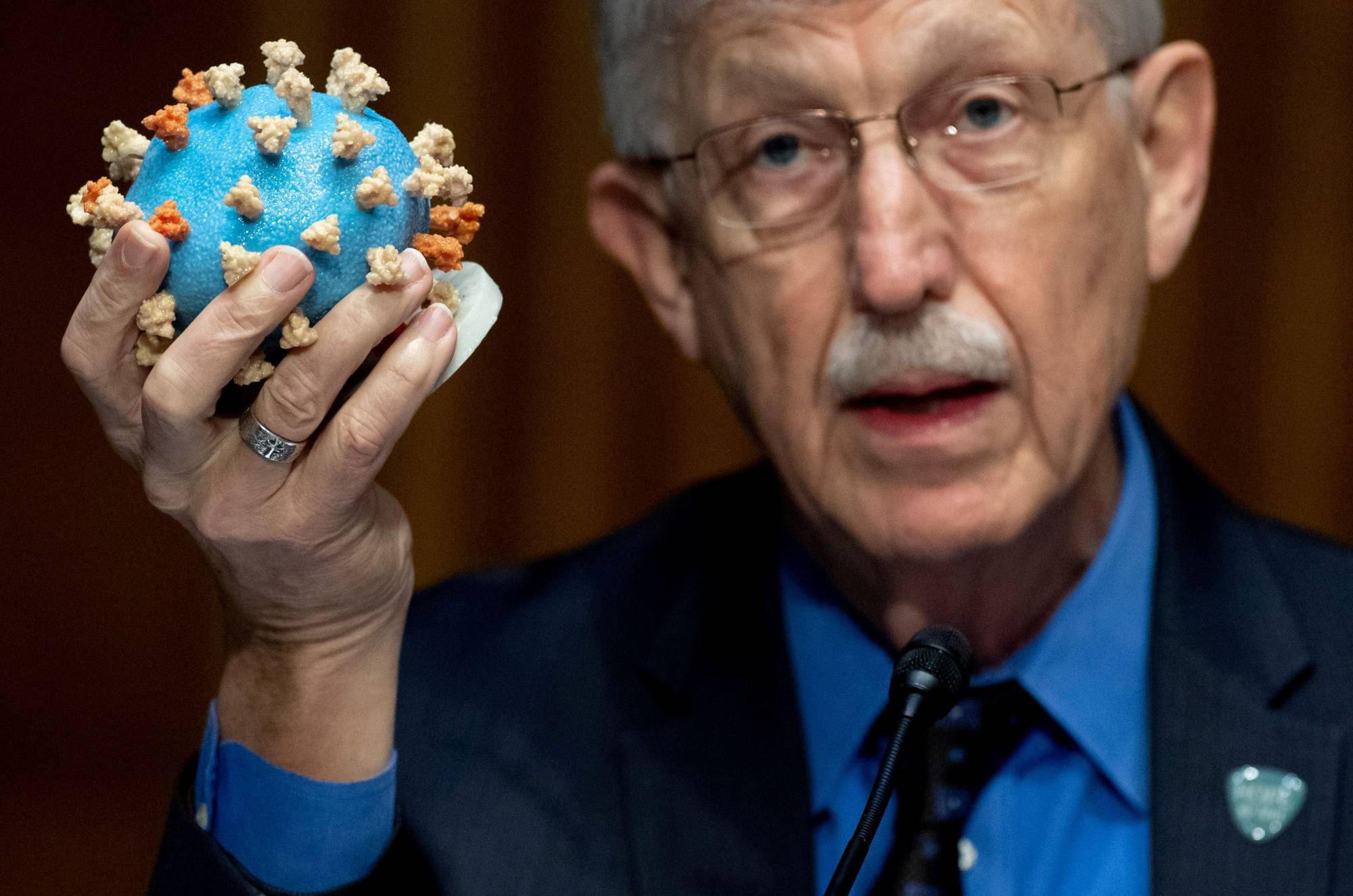 Dr Francis Collins, director of the National Institutes of Health, holds up a model of SARS-CoV-2, known as the novel coronavirus, during a U.S. Senate Appropriations Subcommittee Hearing on the plan to research, manufacture and distribute a coronavirus vaccine, known as Operation Warp Speed on Capitol Hill in Washington on July 2. | REUTERS