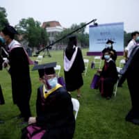 Undergraduate students attend a graduation ceremony at Tsinghua University in Beijing on June 23. | REUTERS
