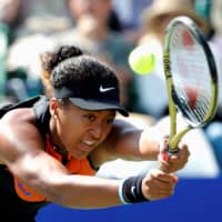 Naomi Osaka returns the ball during her Pan Pacific Open quarterfinal match on Sept. 21 in Osaka. | REUTERS