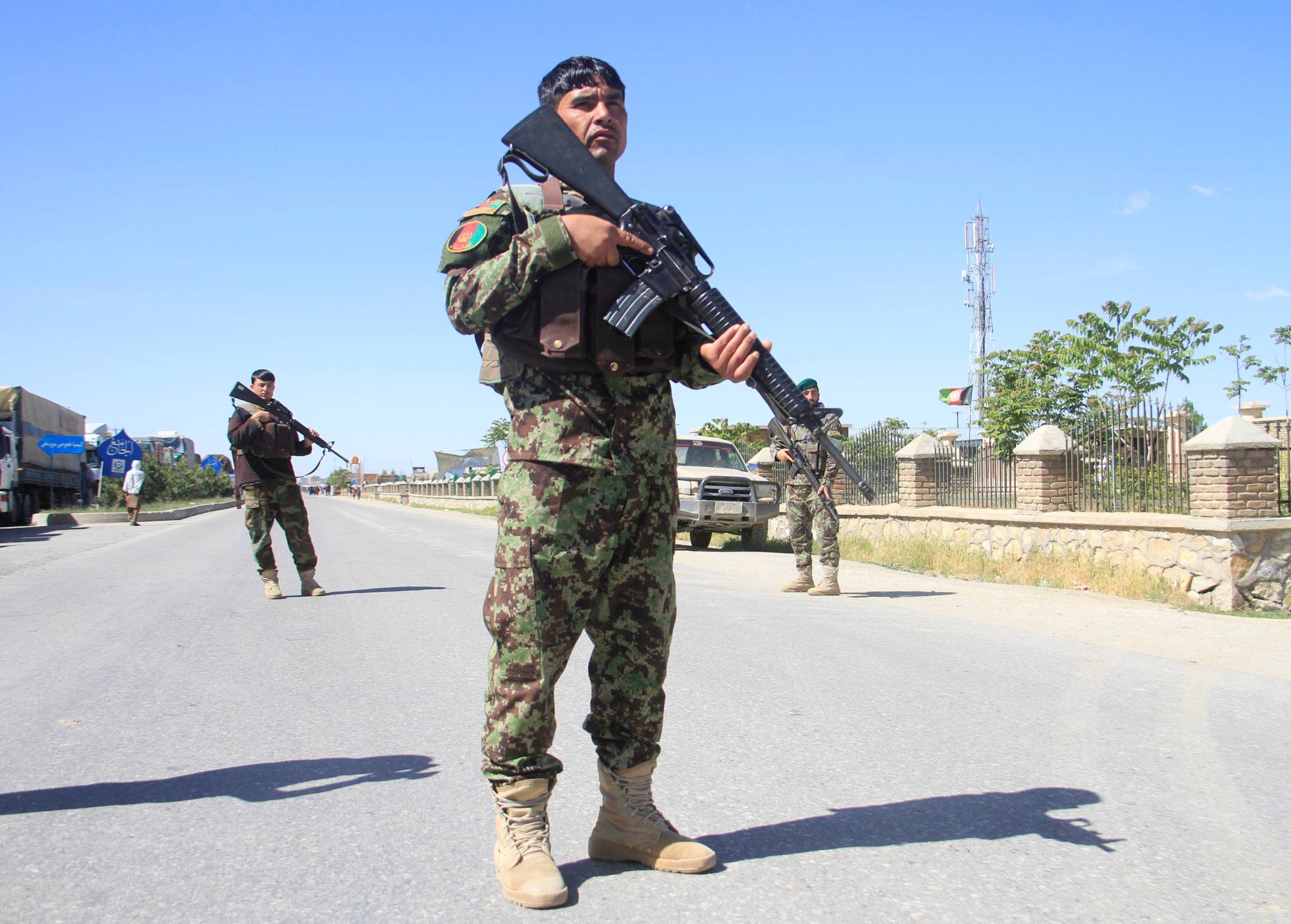 Afghan National Army officers stand guard at the site of a blast in Ghazni province, Afghanistan, on May 18.  | REUTERS / MUSTAFA ANDALEB / FILE PHOTO