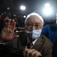 Former Malaysian Prime Minister Najib Razak leaves the Duta Court complex after being found guilty in his corruption trial in Kuala Lumpur on Tuesday. | AFP-JIJI
