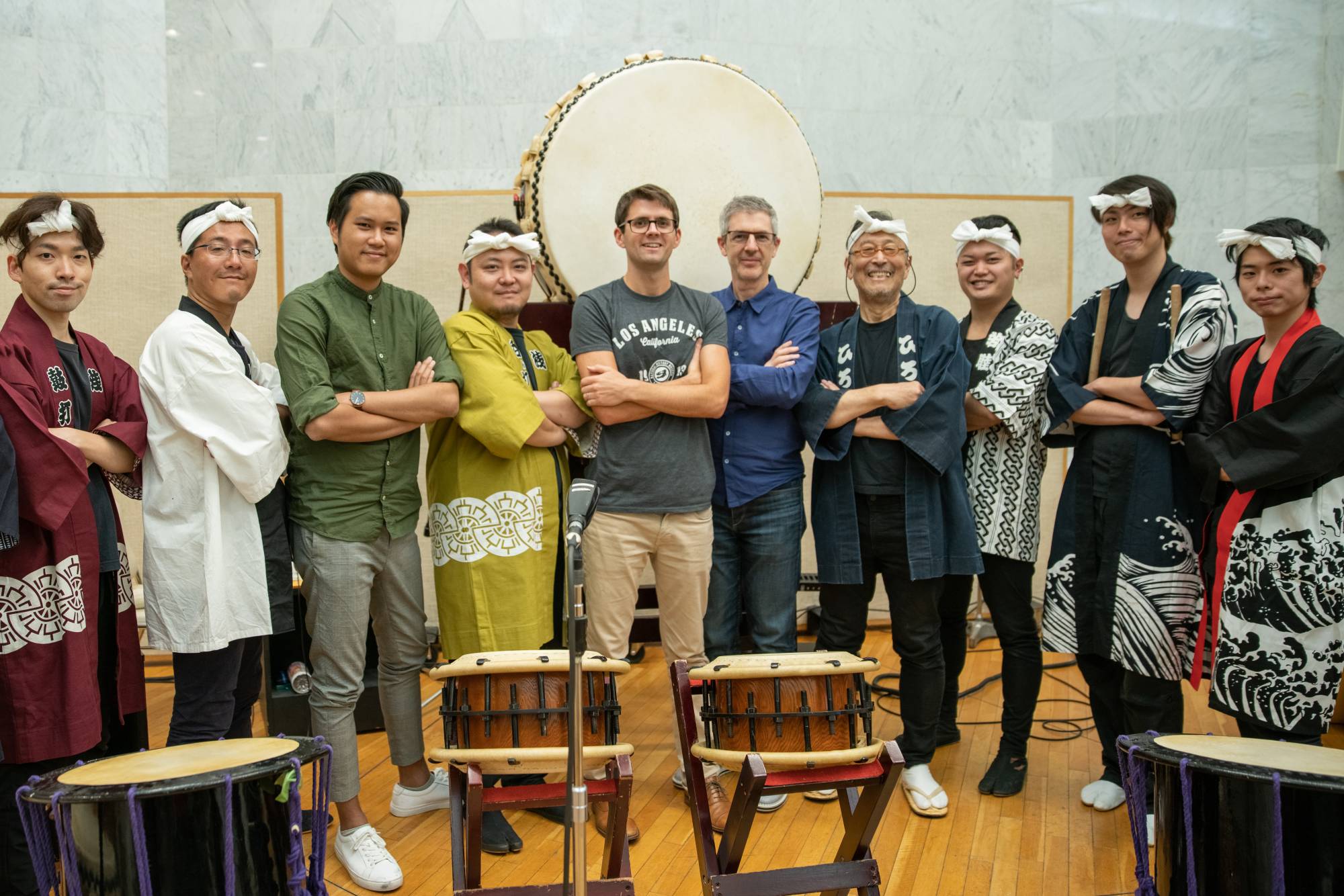 Drum up the drama: Bill Hemstapat (third from left), Chad Cannon (fifth from left), Peter Scaturro (sixth from left) with the taiko ensemble at Sound City studio in Tokyo. | 