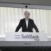 Masayoshi Son, chairman and chief executive officer of SoftBank Group Corp., is seen on a computer speaking during the company\'s annual general meeting in Tokyo last month. | BLOOMBERG 