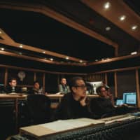 Making music: Producer Peter Scaturro (far left), co-composer Shigeru Umebayashi (center) other members of the scoring team at Air Studios in London.