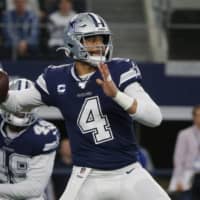 Cowboys quarterback Dak Prescott attempts a pass against the Rams during the first half of their game on Dec. 15, 2019, in Arlington, Texas.  | AP