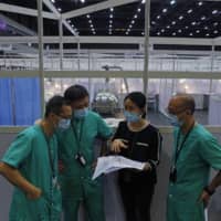 Medical workers prepare a temporary field hospital at Asia World Expo in Hong Kong on Saturday.  | AP