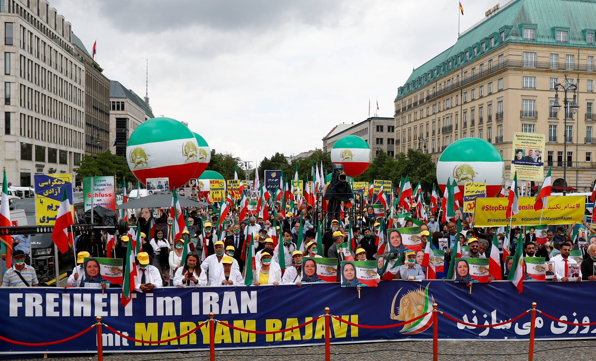 Supporters of Iranian opposition leader Maryam Rajavi and the National Council of Resistance of Iran (NCRI) gather to protest against the death penalty in Iran in front of the Brandenburg Gate in Berlin. | REUTERS