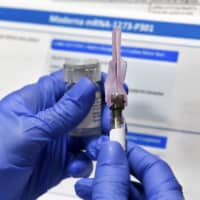 A nurse prepares a shot as a study for a possible COVID-19 vaccine, developed by the National Institutes of Health and Moderna Inc., gets underway in Binghamton, New York, on July 27.
 | GETTY IMAGES