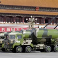 Military vehicles carrying Chinese DF-31A long-range missiles drive past Tiananmen Gate in Beijing during a military parade to mark the 70th anniversary of the end of World War II in September 2015. | REUTERS