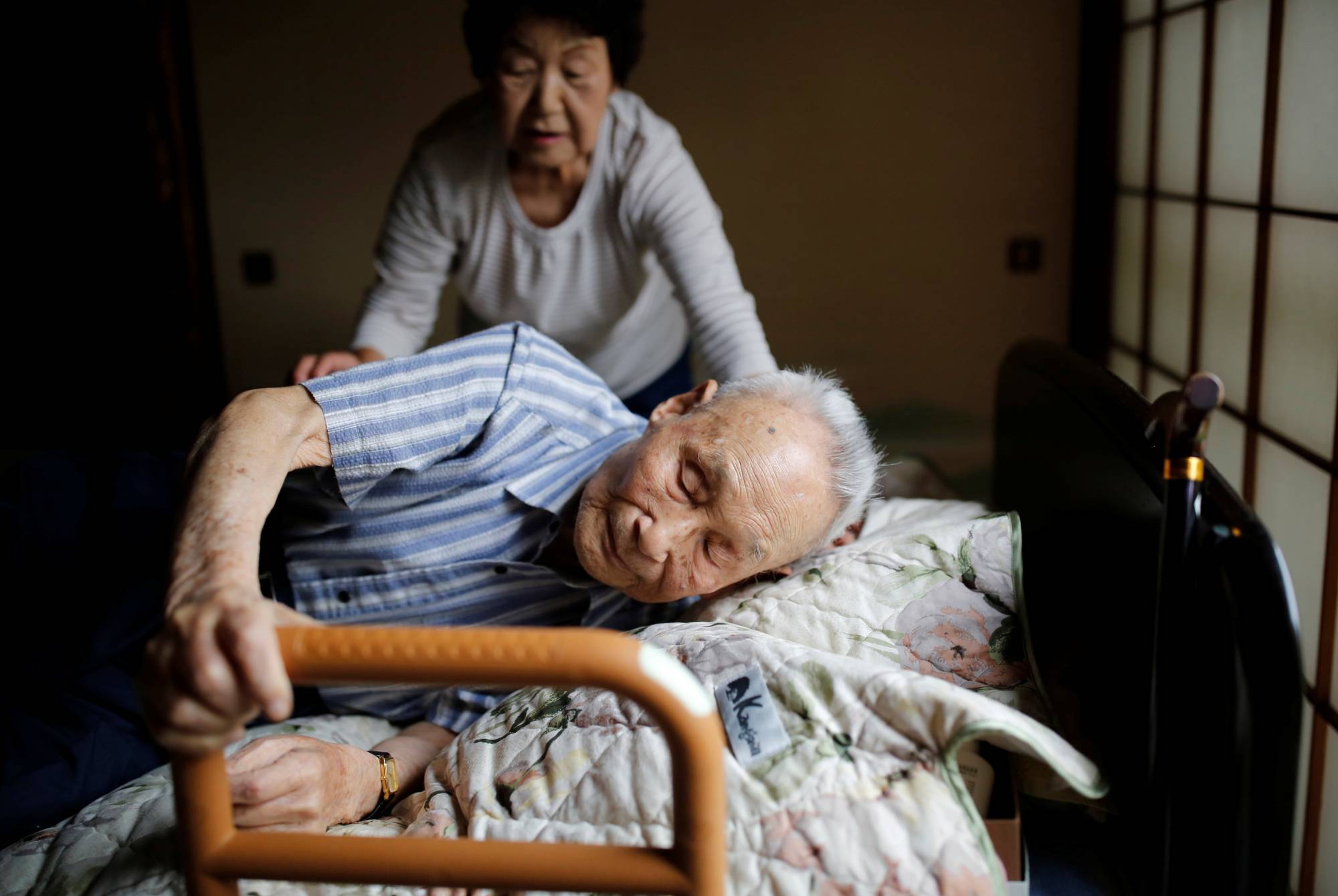 Kang Bok-soon helps her husband, Lee Hak-rae, the last surviving Korean war criminal from World War II. | Reuters