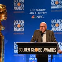 Hollywood Foreign Press Association president Lorenzo Soria tests the microphone ahead of the 77th Annual Golden Globe Awards nominations announcement at the Beverly Hilton hotel in Beverly Hills on Dec. 9. | AFP-JIJI