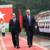 Escorted by Vietnamese President Tran Dai Quang, U.S. President Donald Trump reviews an honor guard in Hanoi during his state visit on Nov. 11, 2017. | WHITE HOUSE
