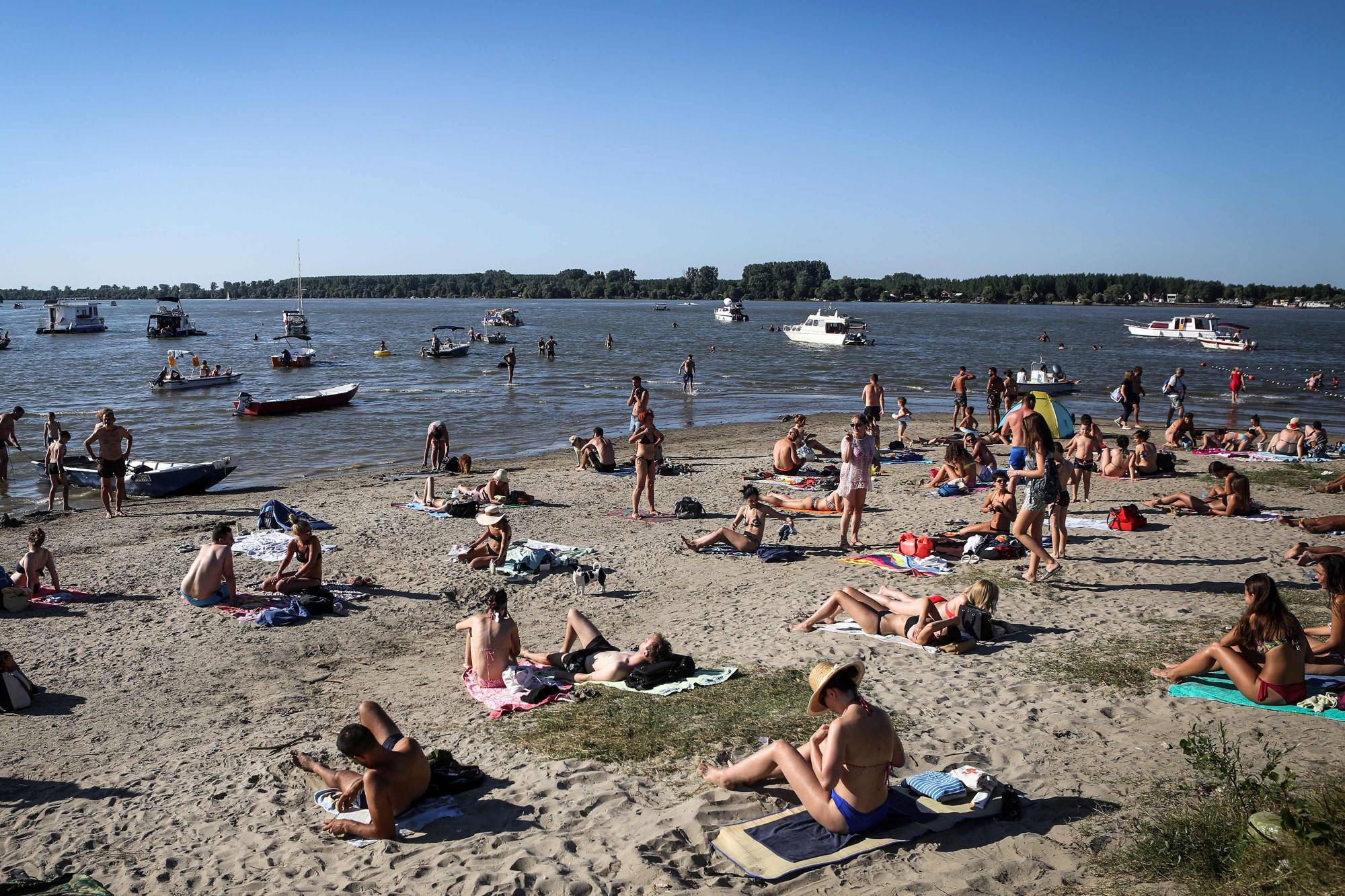 People cool off in the waters of the Danube river in Belgrade on Saturday as Serbia endures a heat wave. | AFP-JIJI