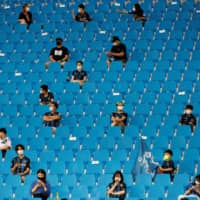 South Korean soccer fans enjoy a game in Incheon on Aug. 1 as matches resume with spectators for the first time since the outbreak of COVID-19. | REUTERS 