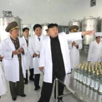 North Korean leader Kim Jong Un gives guidance at the Ryongmun Liquor Factory in this undated photo released by North Korea\'s Korean Central News Agency in Pyongyang in May 2014. | KCNA / VIA REUTERS