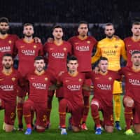 Roma players pose for a team photo before their Europa League round of 32 match against Gent on Feb. 20 in Rome. | REUTERS