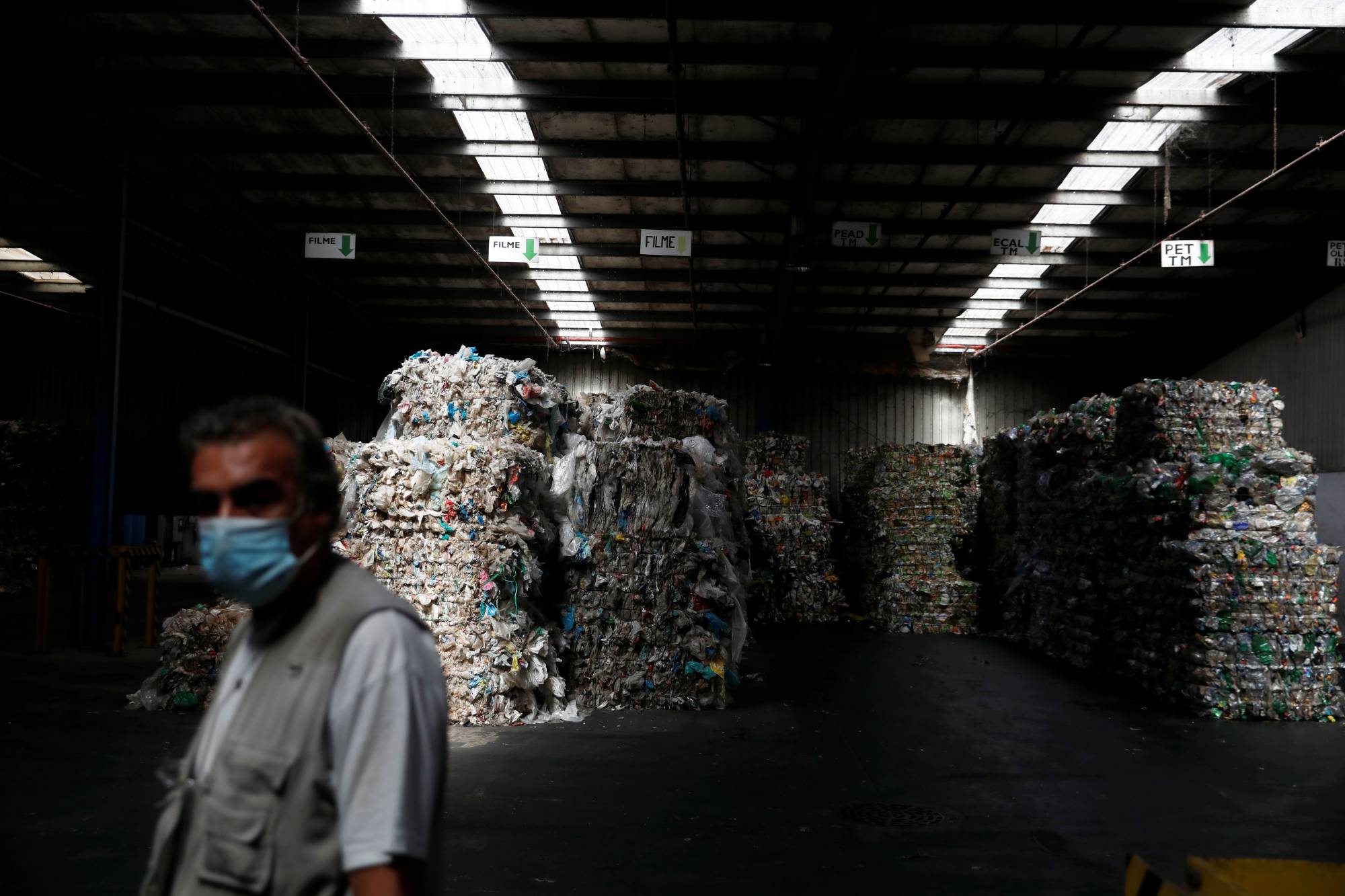 Stacks of plastics are stored for distribution to recycling companies at the Amarsul plant in Seixal, Portugal, on July 7. | REUTERS