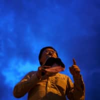 Anon Nampa, one of the leaders of recent anti-government protests, speaks during a demonstration demanding the resignation of Thailand\'s Prime Minister Prayut Chan-ocha in Chiang Mai, Thailand, on Sunday. |  REUTERS