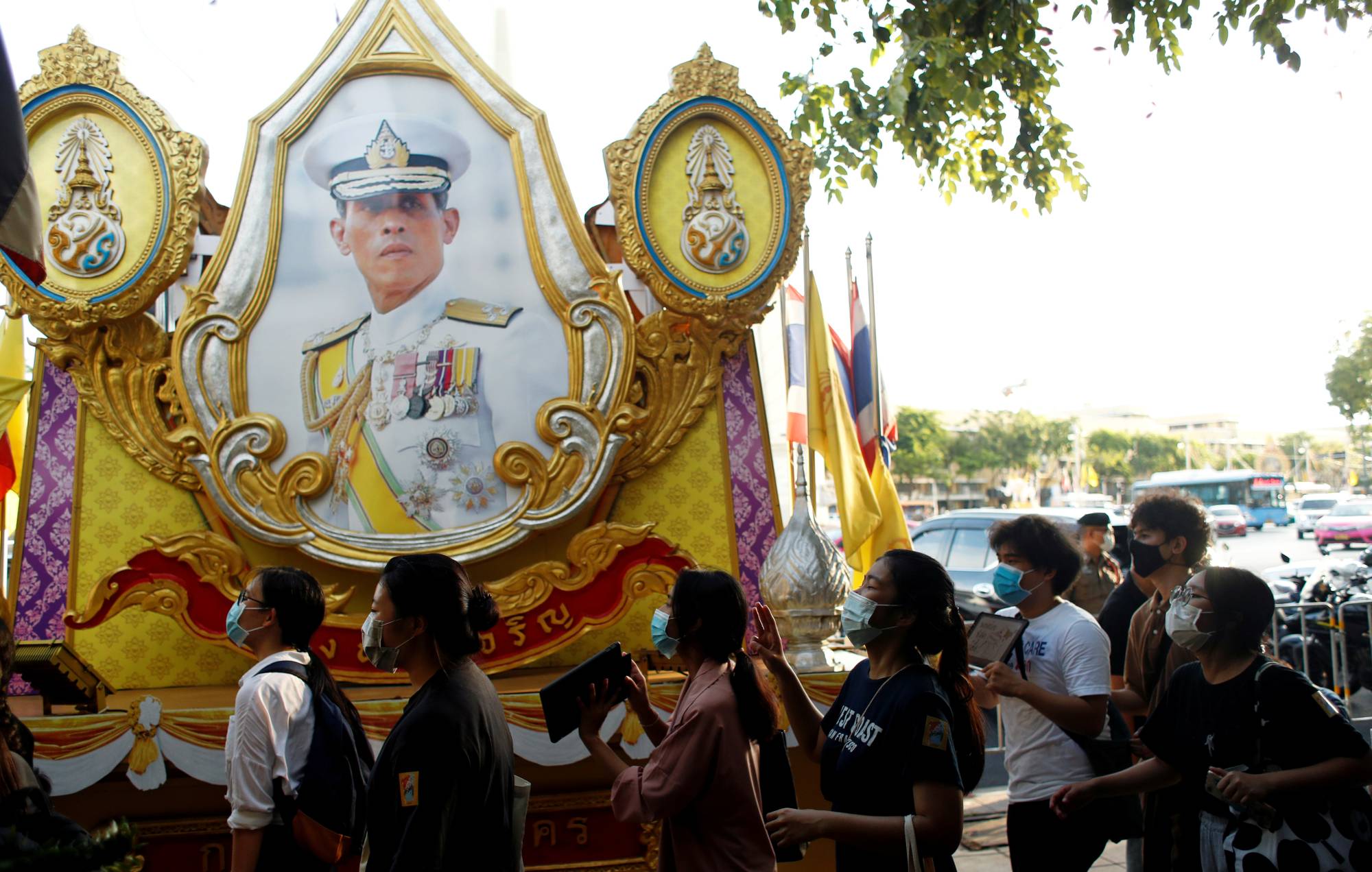 Demonstrators walk past a portrait of Thai King Maha Vajiralongkorn during a protest demanding the resignation of Thailand's Prime Minister Prayut Chan-ocha, in Bangkok on July 26. | REUTERS