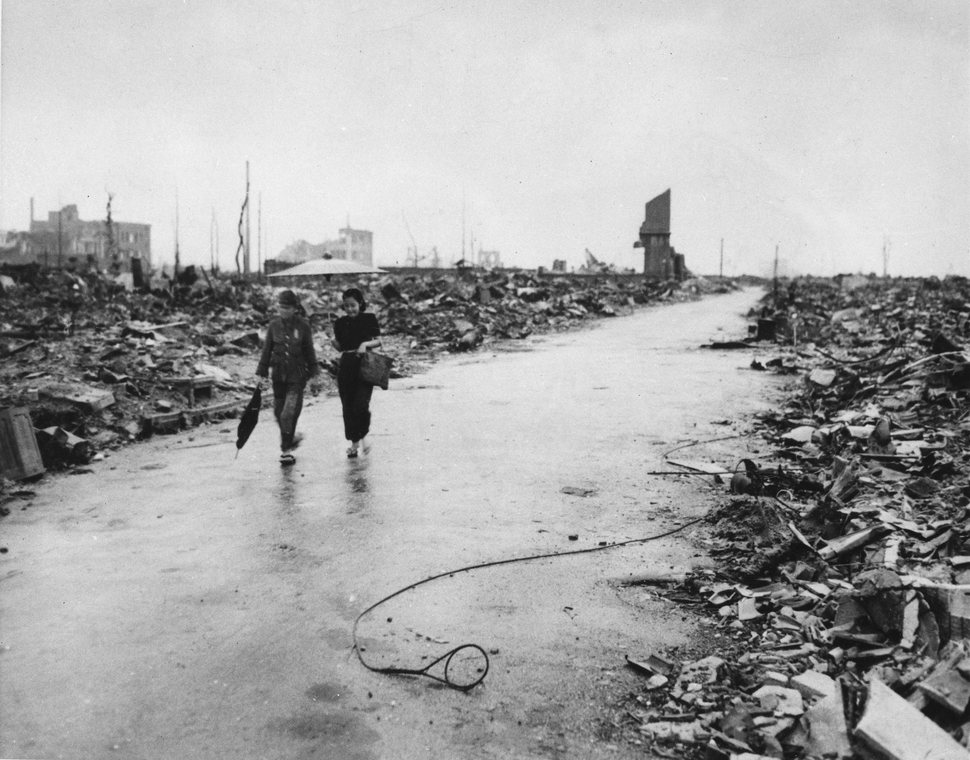 In this Sept. 8, 1945, file photo released by the U.S. Air Force, two people are seen walking on a path through the destruction that resulted from the Aug. 6 atomic bombing of Hiroshima. | U.S. AIR FORCE VIA AP