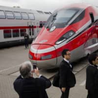 People take pictures of a Frecciarossa 1000 high-speed train by Bombardier Transportation at the InnoTrans railway technology trade fair in Berlin in September 2014. | REUTERS