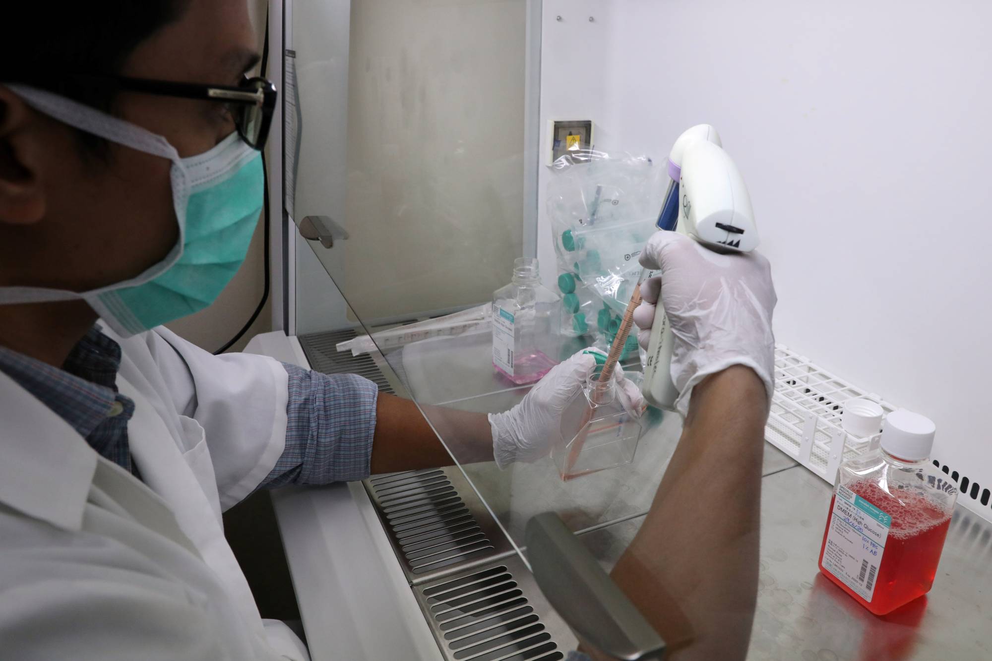 A researcher prepares Sumatran Rhinoceros cells for research at a laboratory of International Islamic University of Malaysia in Kuantan on June 30. | REUTERS