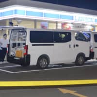 Investigators examine the Lawson convenience store in Utsunomiya, Tochigi Prefecture, where a store clerk was stabbed to death Wednesday. | KYODO