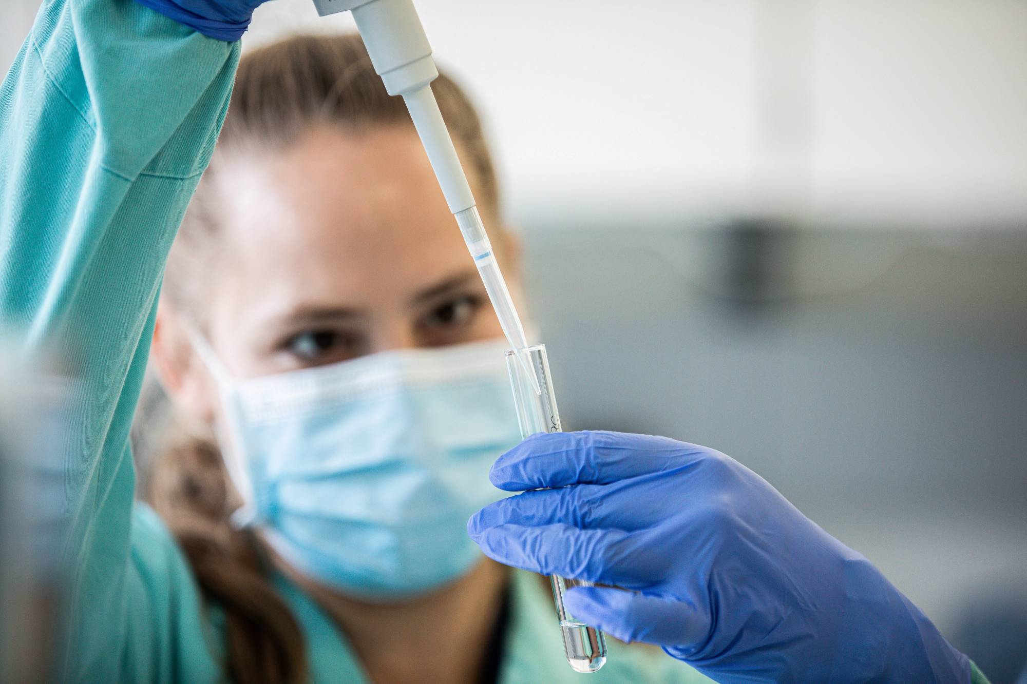 A lab technician conducts coronavirus vaccine research at Valneva SA laboratories in Vienna. | BLOOMBERG