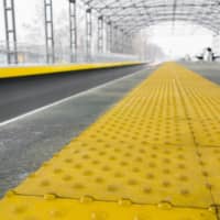 Blocks featuring a raised \"blister\" pattern line the edge of the platform at a train station in Japan to warn people with visual impairments to exercise caution. | GETTY IMAGES