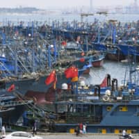 Chinese fishing boats wait to depart a port in Shishi, in China\'s Fujian province, on Saturday. | KYODO