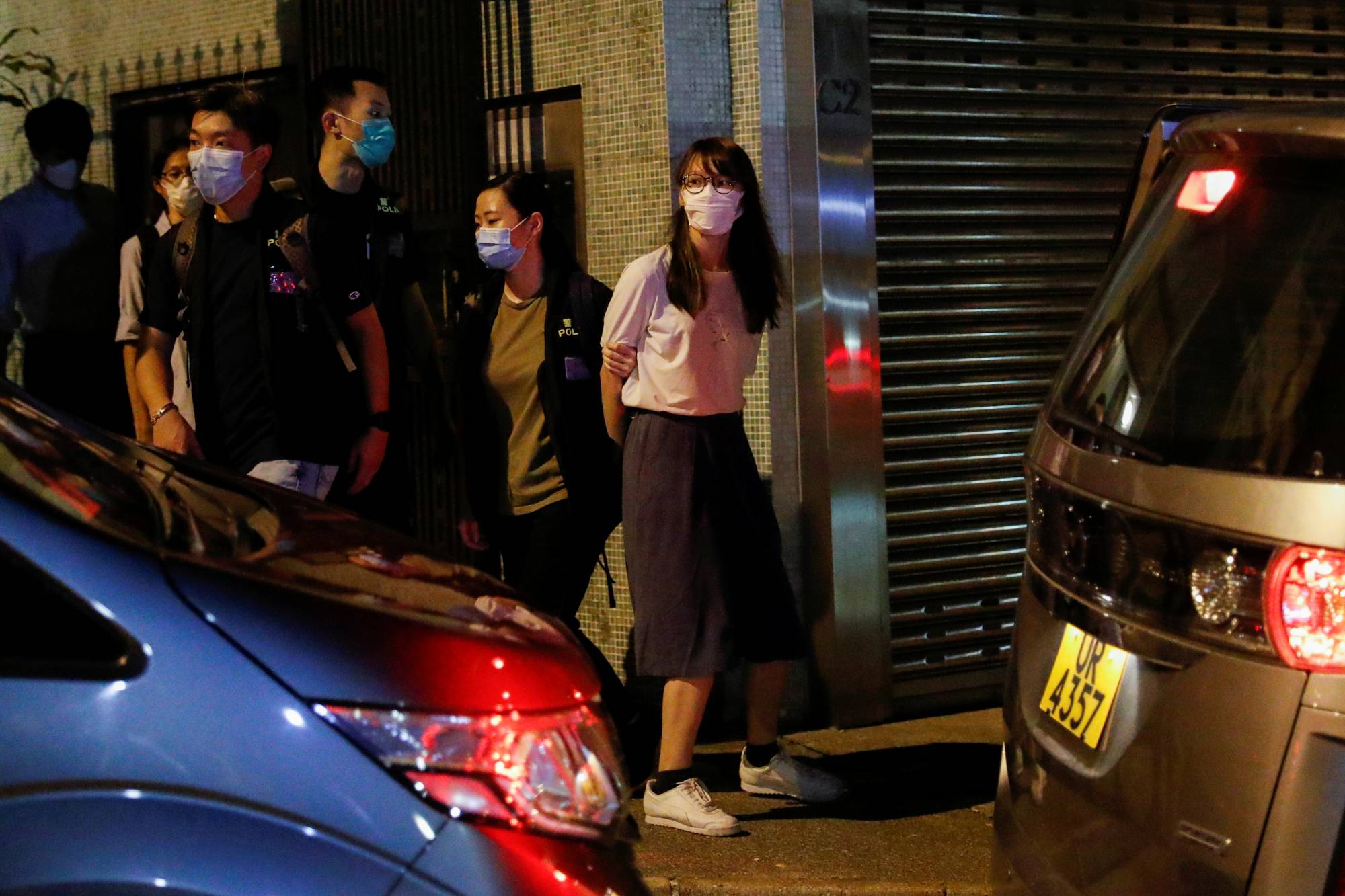 Pro-democracy activist Agnes Chow is arrested in Hong Kong on Aug. 10. | REUTERS