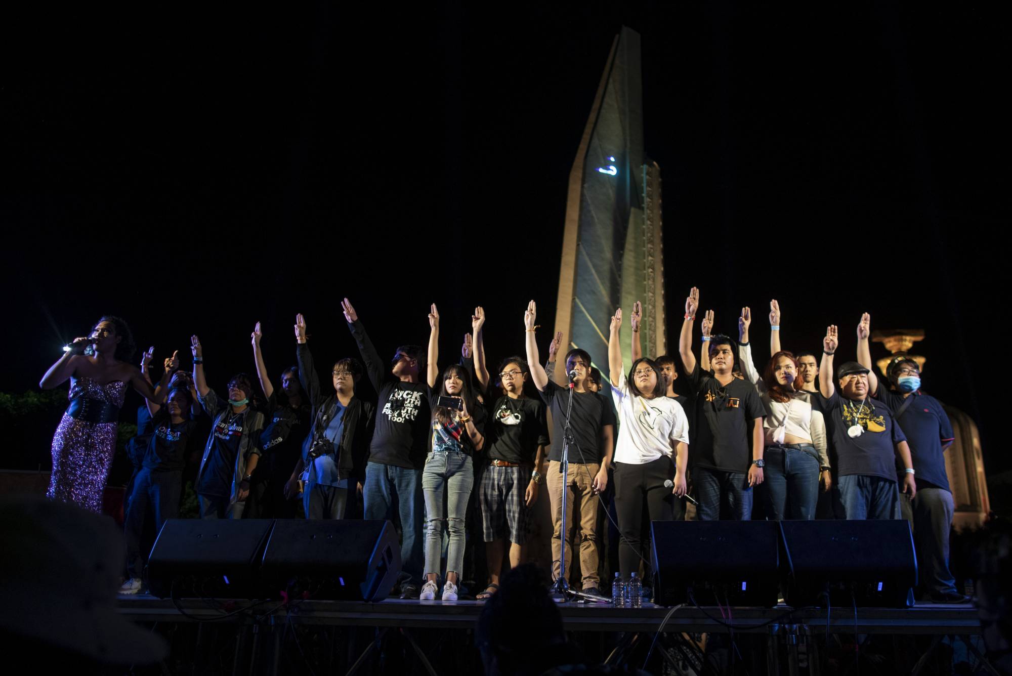 Pro-democracy activist and student leaders greet supporters after a protest rally at Democracy Monument in Bangkok on Sunday. | AP