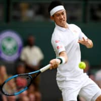 Kei Nishikori hits a return against Roger Federer during their quarterfinal match at Wimbledon on July 10, 2019. | REUTERS