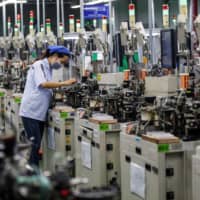 Countries like Japan cannot afford to ignore the rise of China as a manufacturing power. | STR / VIA AFP-JIJI