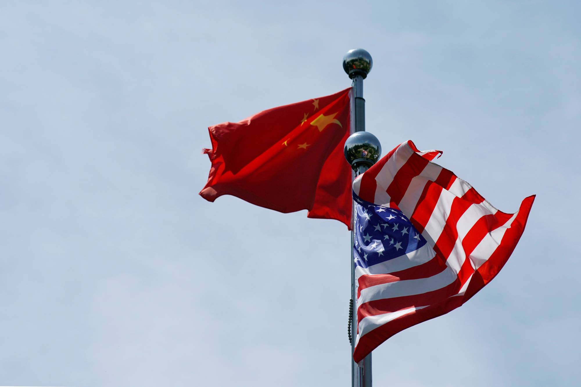 Chinese and U.S. flags flutter near The Bund before the U.S. trade delegation meet their Chinese counterparts for talks in Shanghai in July 2019. | REUTERS
