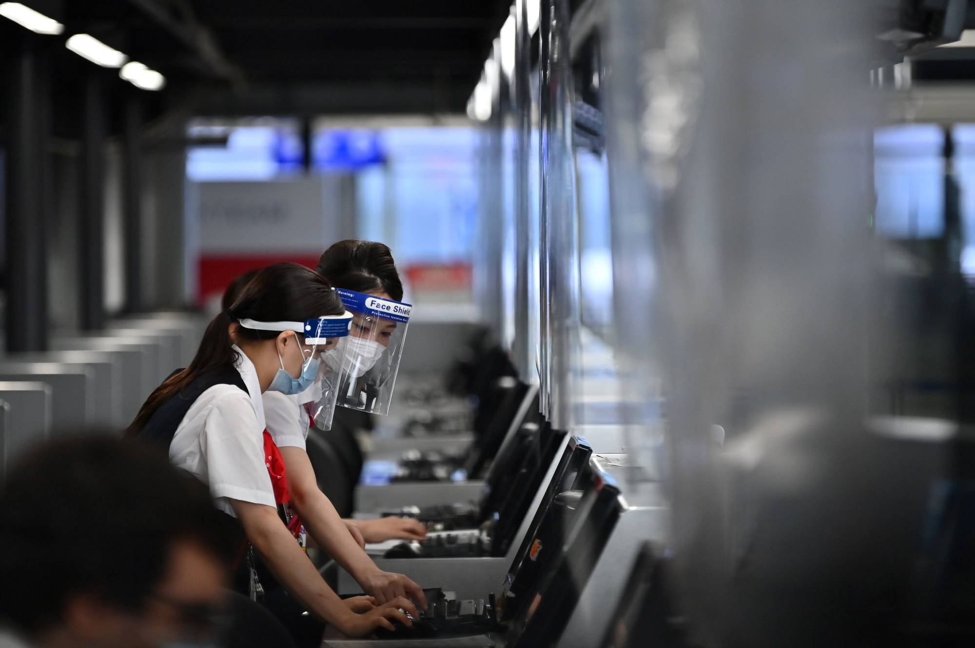 Airline employees work at Narita International Airport in Chiba Prefecture. | AFP-JIJI