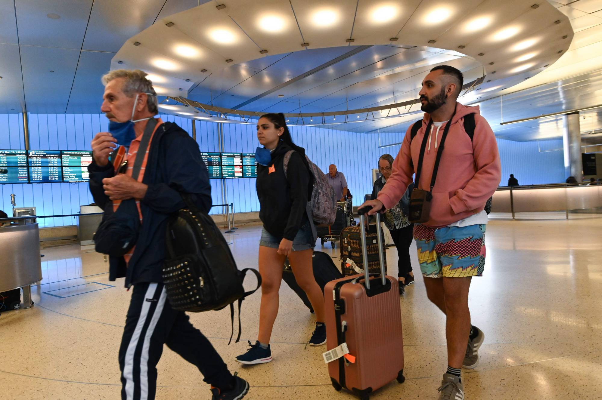 Passengers arrive at Los Angeles Airport's international terminal hours before the start of the European travel ban on March 13.  | AFP-JIJI