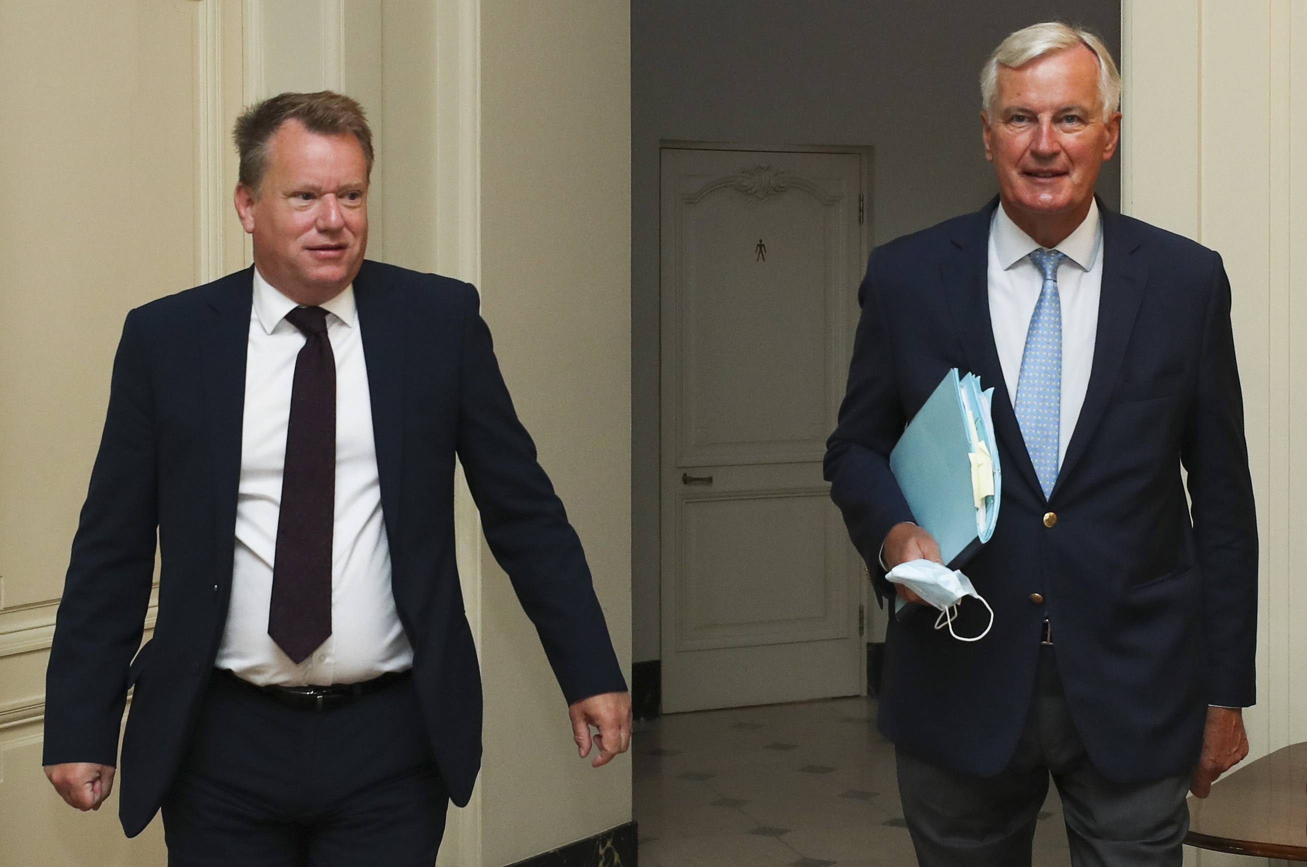 European Union chief Brexit negotiator Michel Barnier (right) and the British prime minister's Europe adviser David Frost arrive for talks on Friday in Brussels.  | POOL / VIA AP
