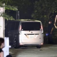 A van carrying House of Representative member  Tsukasa Akimoto enters the Tokyo Detention House on Thursday. | KYODO 