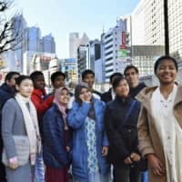 Foreign students pose for a photo on their way to attending their coming-of-age ceremony in Tokyo in January 2019. | KYODO
