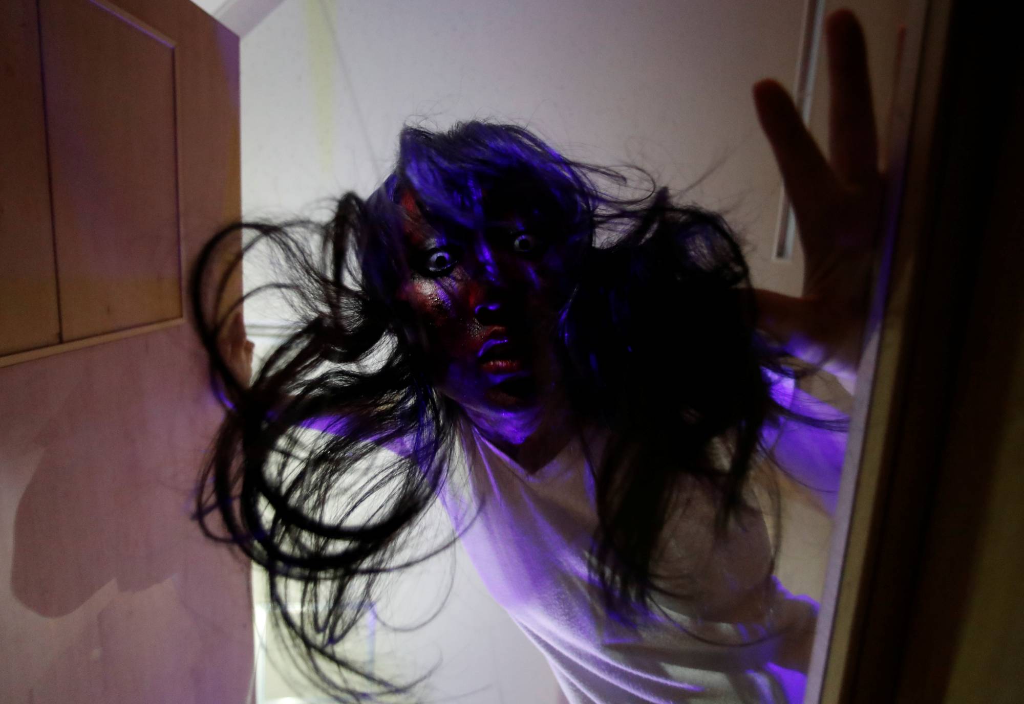 An actor dressed as zombie performs during a coffin horror show performed by Kowagarasetai (Scare Squad) in Tokyo on Saturday. | REUTERS