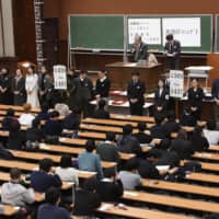Students take an entrance exam at the University of Tokyo in January. | KYODO
