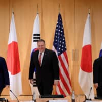 South Korean Foreign Minister Kang Kyung-wha (left), U.S. Secretary of State Mike Pompeo (center) and Japan\'s Foreign Minister Toshimitsu Motegi arrive for a trilateral meeting in Munich last February. | POOL / VIA REUTERS