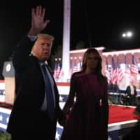 U.S. President Donald Trump waves while greeting Republican National Convention attendees alongside first lady Melania Trump in Baltimore, Maryland, on Wednesday.  | BLOOMBERG