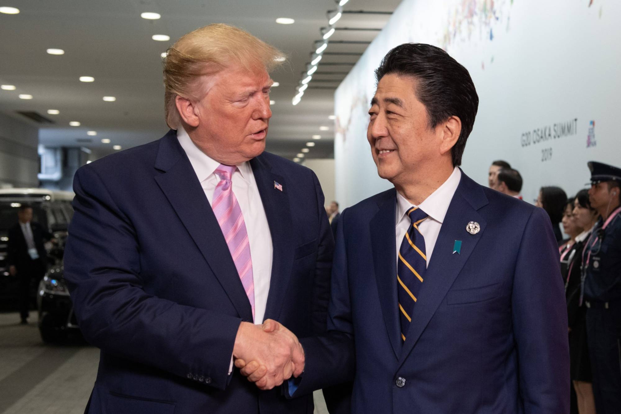 U.S. President Donald Trump is greeted by Prime Minister Shinzo Abe at the Group of 20 summit in Osaka on June 28, 2019. | BLOOMBERG