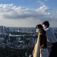 People visit an observation deck in Tokyo on Thursday. | AFP-JIJI