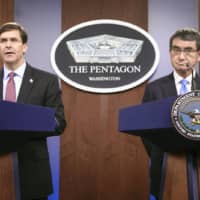 U.S. Secretary of Defense Mark Esper and Defense Minister Taro Kono hold a news conference after talks at the Pentagon near Washington in January. | POOL / VIA KYODO
